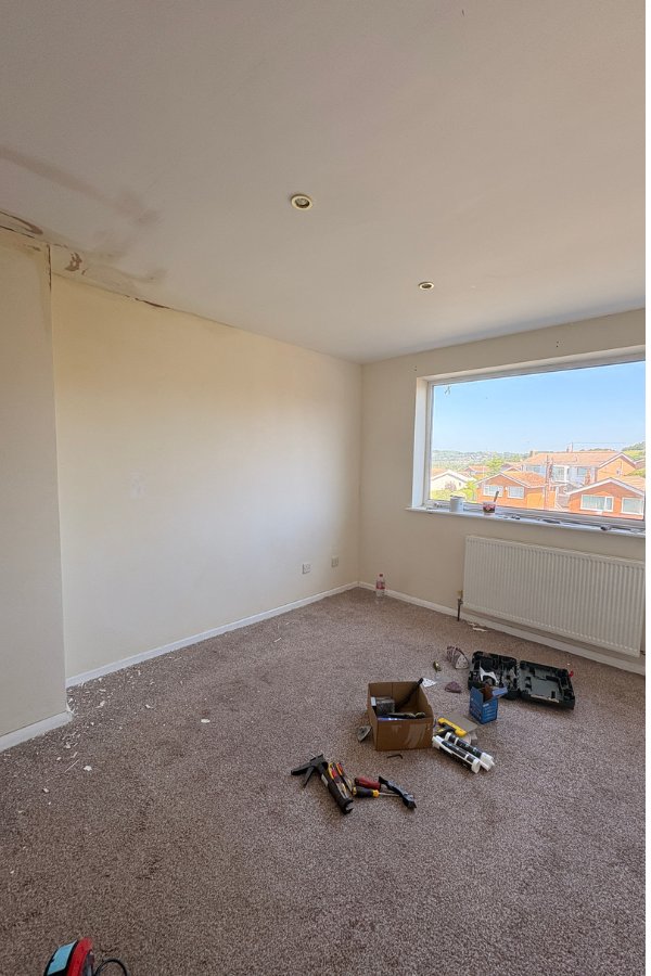 Bedroom before repaint – tired, unfinished walls, Conwy