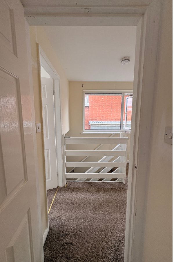 Landing before repaint, North Wales property