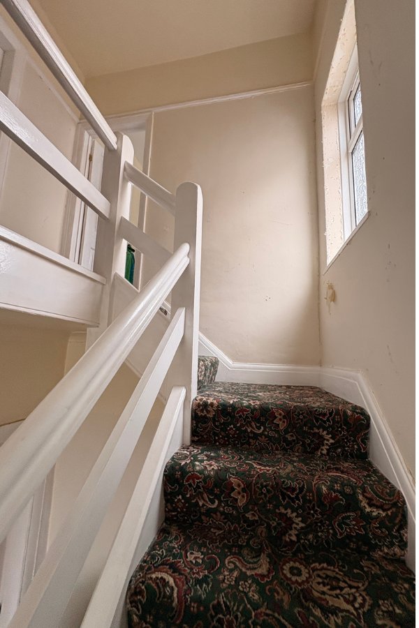 Staircase before repaint, dated yellow paintwork